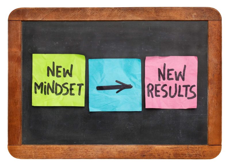 Mini board with post its promoting adapting a new mindset and positive results